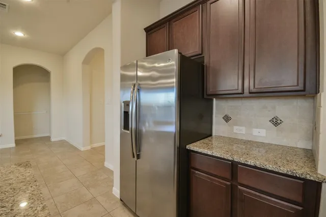 a kitchen with metallic refrigerator freezer and a dishwasher