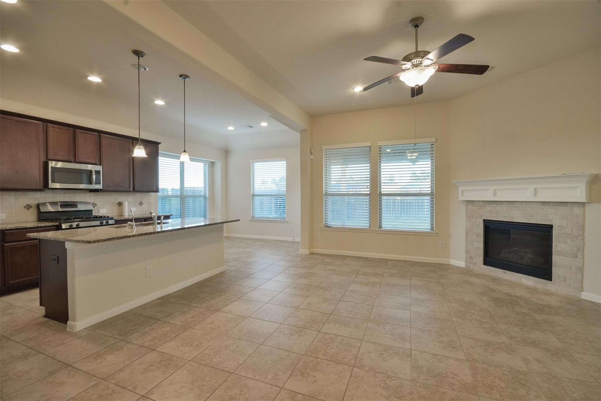 3643 Cottage Pines Lane Spring, TX 77386 - Photo 9 of 33 a large kitchen with granite countertop a stove top oven a sink a counter space and cabinets