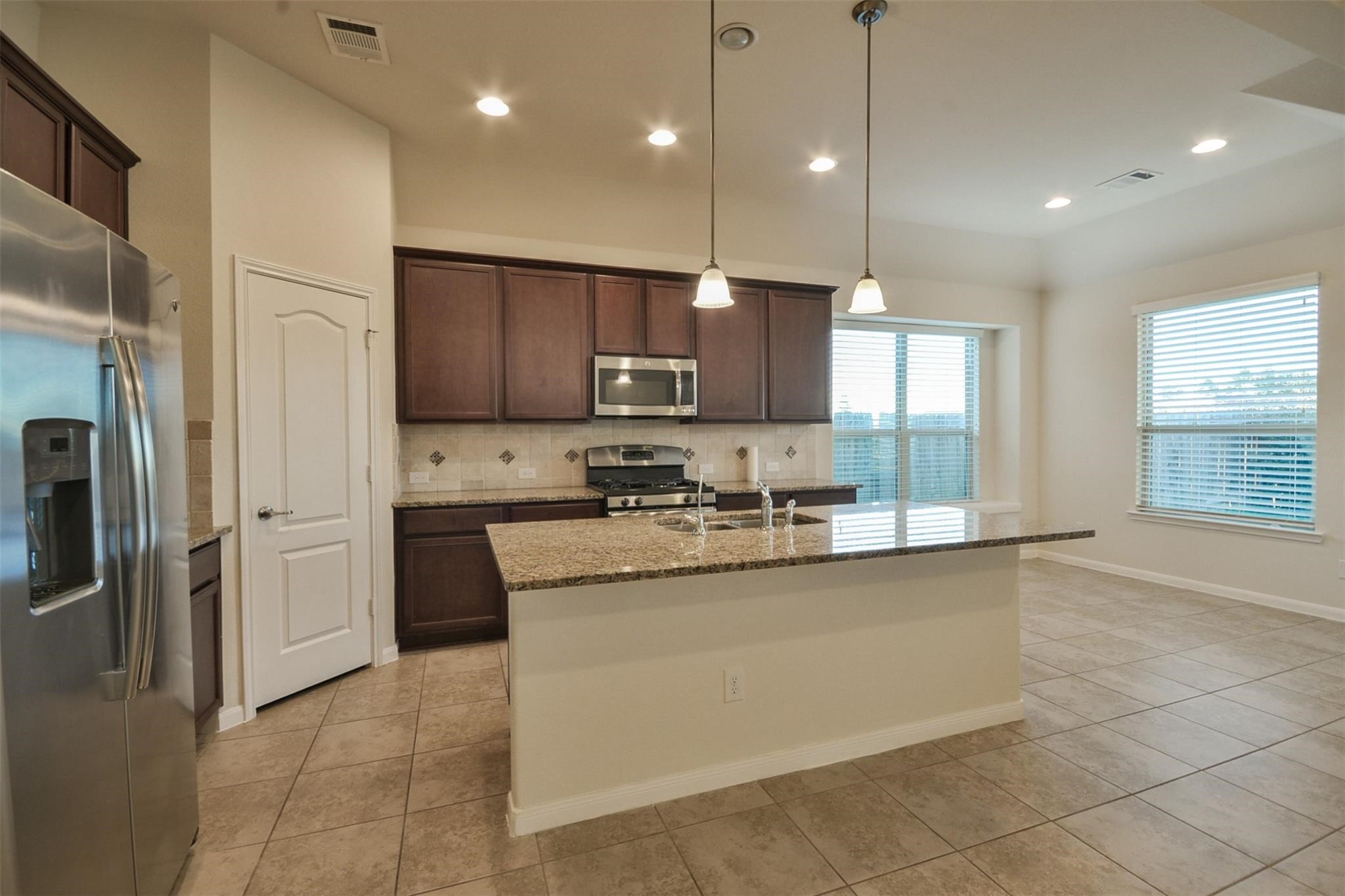 3643 Cottage Pines Lane Spring, TX 77386 - Photo 10 of 33 a kitchen with stainless steel appliances granite countertop a refrigerator a sink and a stove
