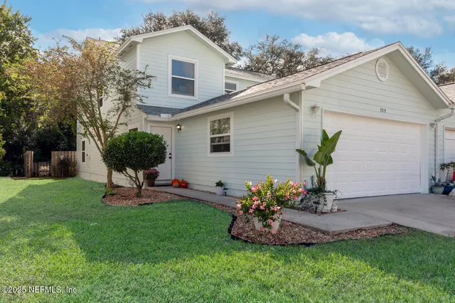 a front view of a house with a yard and seating space