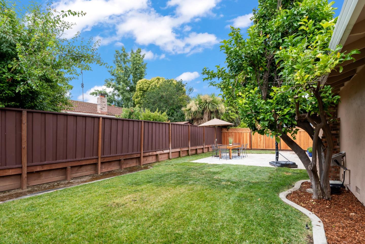 1110 Castleton Way Sunnyvale, CA 94087 - Photo 26 of 27 a view of a backyard with a small cabin and a chair