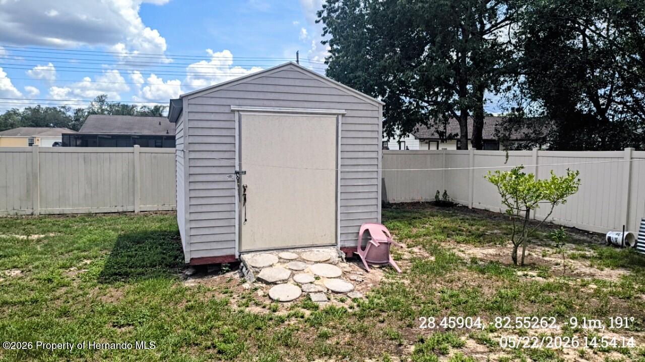 10244 Heathcliff Street Spring Hill, FL 34608 - Photo 27 of 30 a front view of a house with garden