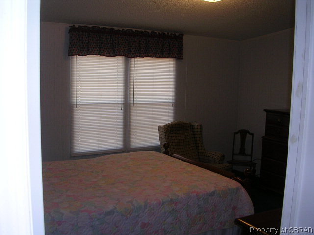 1239 Tabernacle Road Mathews, VA 23109 - Photo 12 of 22 a bedroom with a bed and a window