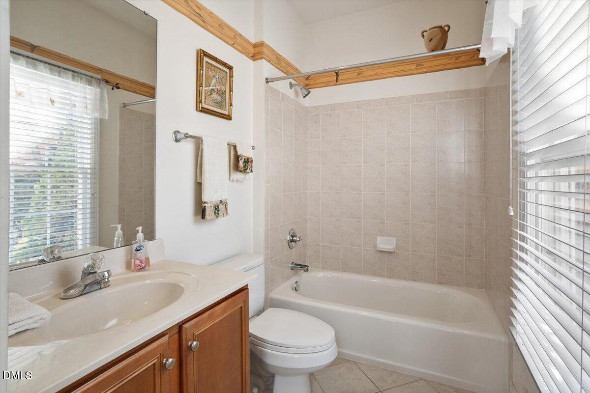 9120 Sanctuary Court Raleigh, NC 27617 - Photo 16 of 80 a bathroom with a sink a toilet and a bathtub