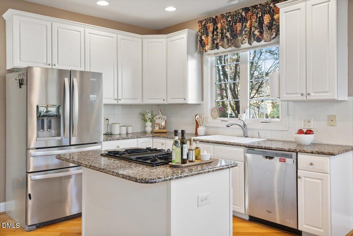 9120 Sanctuary Court Raleigh, NC 27617 - Photo 29 of 80 a kitchen with a sink stove and cabinets
