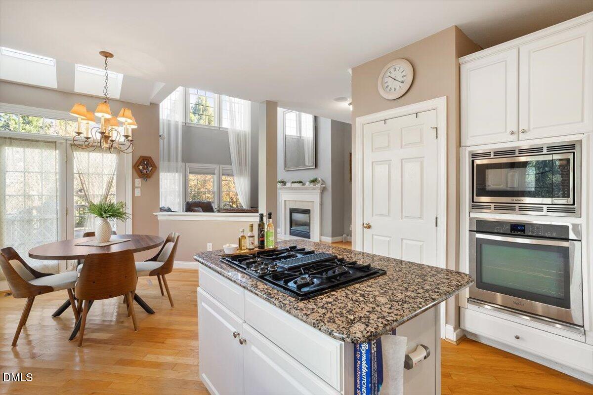 9120 Sanctuary Court Raleigh, NC 27617 - Photo 30 of 80 a kitchen with a stove and a microwave