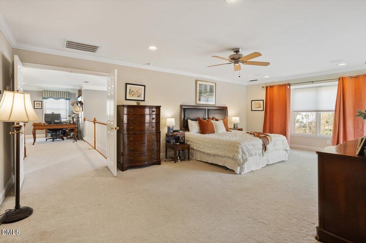 9120 Sanctuary Court Raleigh, NC 27617 - Photo 36 of 80 a bedroom with a bed closet and a flat tv screen