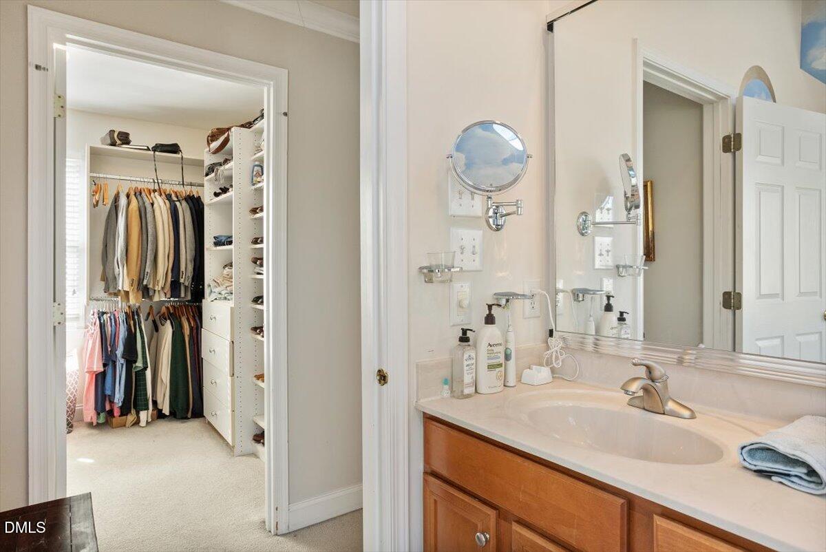 9120 Sanctuary Court Raleigh, NC 27617 - Photo 39 of 80 a en suite bathroom with a sink and a mirror