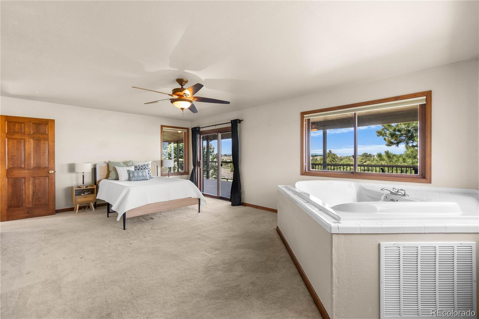 74 Rocky Cliff Road Elizabeth, CO 80107 - Photo 22 of 50 a spacious bedroom with a bed and a window