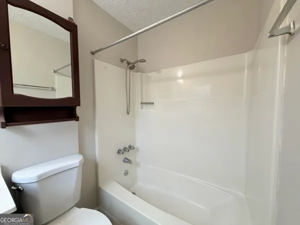a bathroom with a toilet and a bathtub