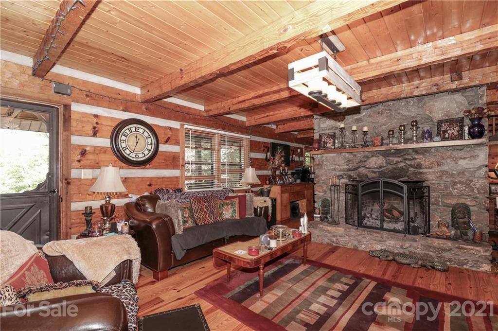 36 Maney Branch Road Weaverville, NC 28787 - Photo 14 of 42 a living room with furniture a clock and a fireplace