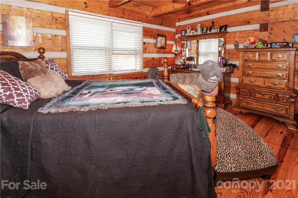 36 Maney Branch Road Weaverville, NC 28787 - Photo 17 of 42 a bed sitting in a bedroom next to a window