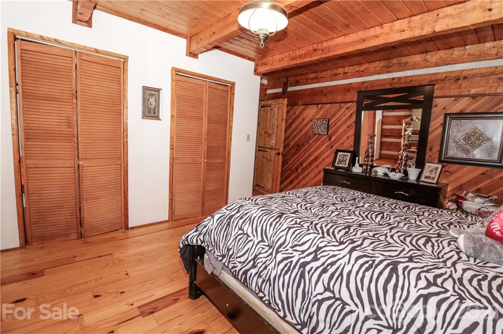 36 Maney Branch Road Weaverville, NC 28787 - Photo 21 of 42 a bedroom with a bed and wooden floor