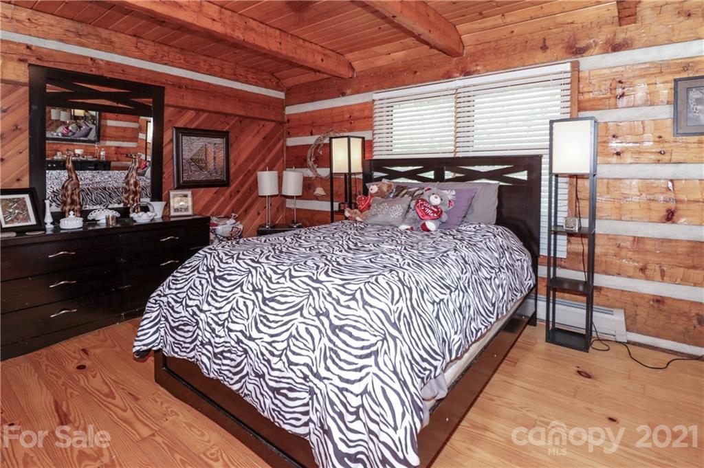 36 Maney Branch Road Weaverville, NC 28787 - Photo 22 of 42 a bed sitting in a bedroom next to a window