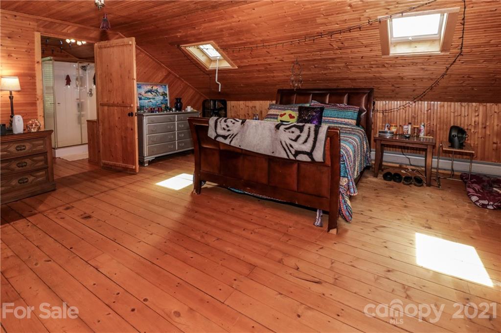 36 Maney Branch Road Weaverville, NC 28787 - Photo 28 of 42 a view of a patio with table and chairs with wooden floor