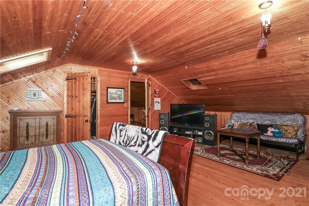 36 Maney Branch Road Weaverville, NC 28787 - Photo 32 of 42 a bedroom with furniture and a flat screen tv