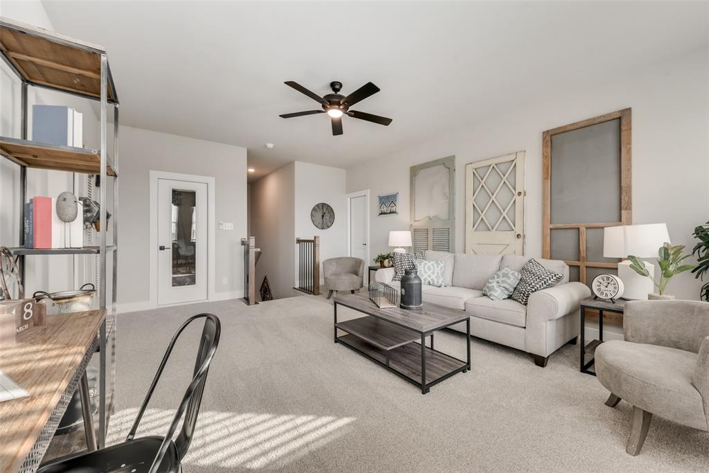 250 Brown Road Leonard, TX 75452 - Photo 17 of 29 Carpeted living area featuring a ceiling fan, a glass-paned interior door, and an open staircase