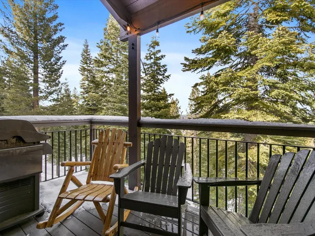 a view of a balcony with chairs and wooden floor