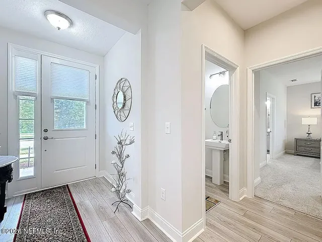 a view of entryway and hall with wooden floor