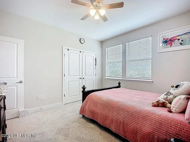 a living room with furniture and large windows