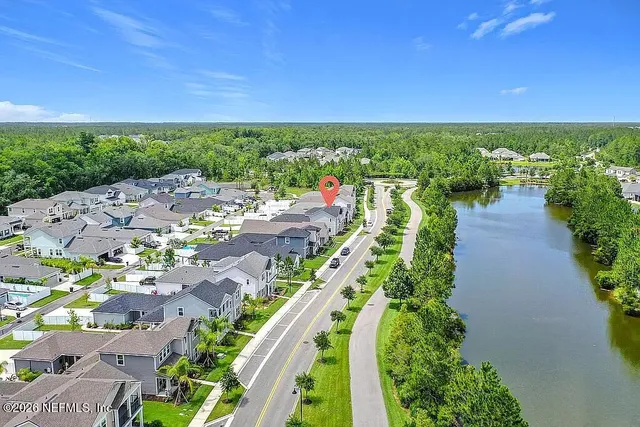 a aerial view of multiple houses with a big yard
