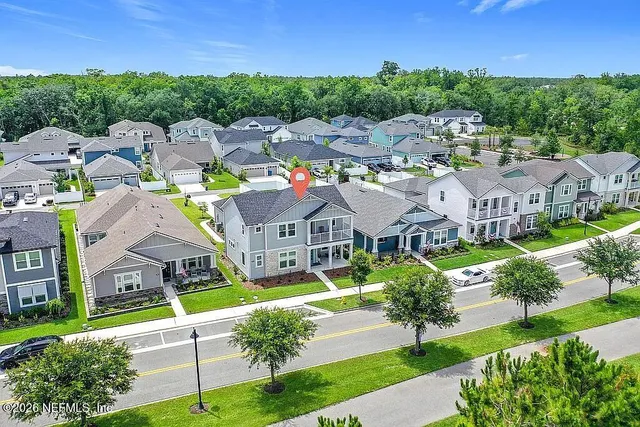 a view of a room that has a table and a chair in it