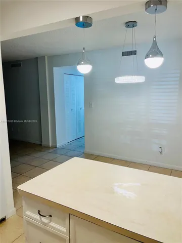 a view of a livingroom with an empty space and a sink