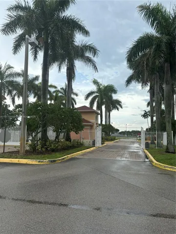 a view of a yard with palm trees