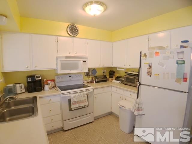 6570 Lotus Street Reno, NV 89506 - Photo 5 of 10 a kitchen with a sink a stove a refrigerator and a stove