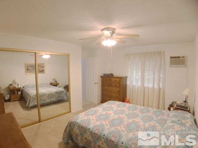 6570 Lotus Street Reno, NV 89506 - Photo 6 of 10 a bedroom with a bed and a chandelier