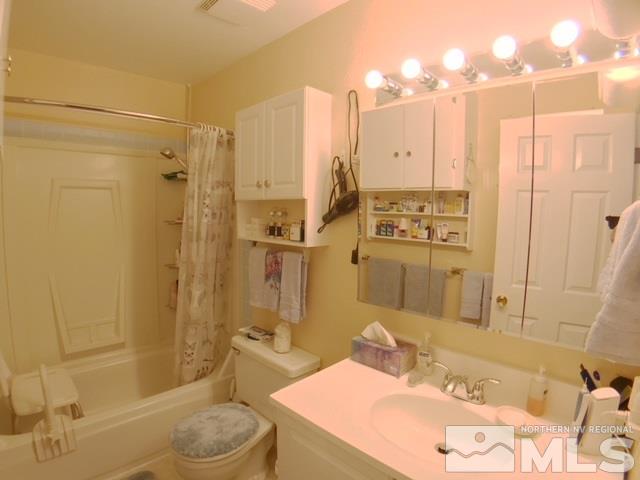 6570 Lotus Street Reno, NV 89506 - Photo 7 of 10 a bathroom with a sink a toilet and shower