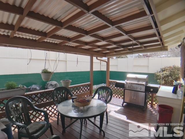 6570 Lotus Street Reno, NV 89506 - Photo 9 of 10 a view of a patio with a table and chairs and a barbeque
