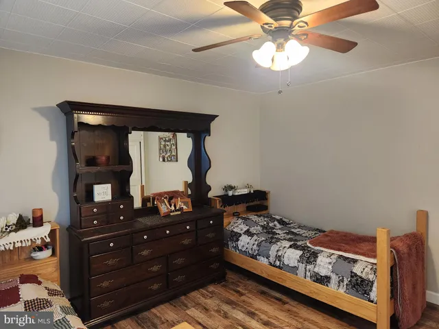 a view of a livingroom with a flesh screen tv and stairs