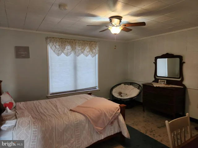 a living room with furniture a dining table and a large window with garden view