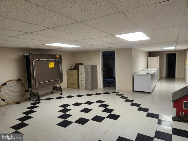 a living room with furniture a flat screen tv and a large window