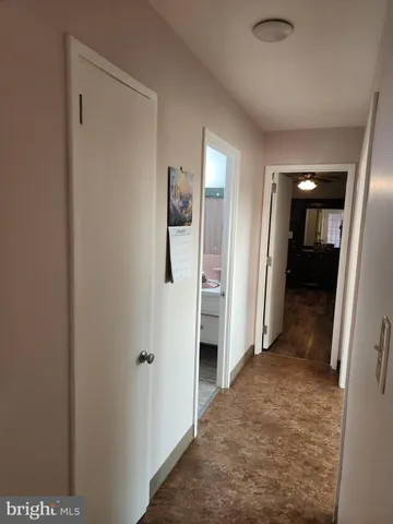 a view of a hallway with paintings on the wall