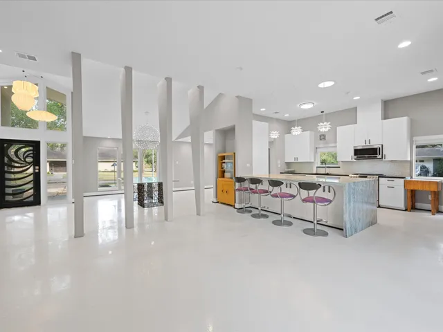a living room with furniture and kitchen view