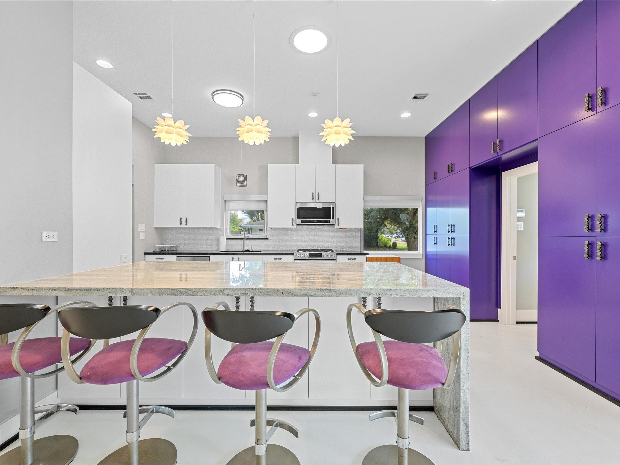 5603 Grape Street Houston, TX 77096 - Photo 14 of 40 a large kitchen with lots of white furniture