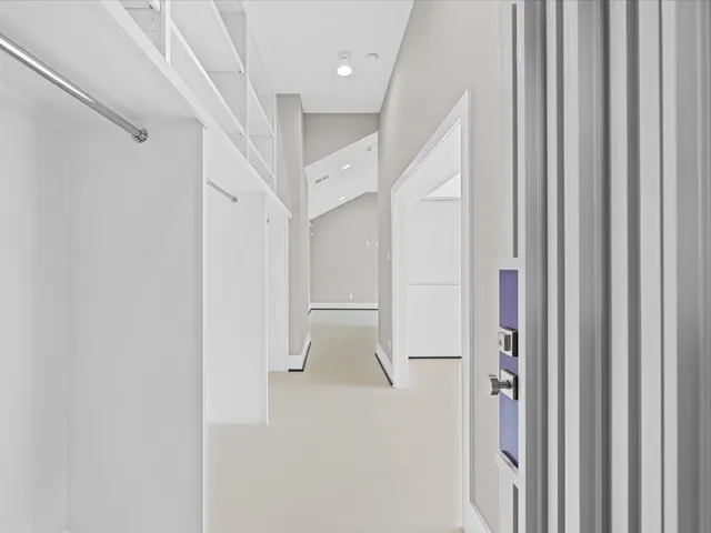 a view of walk in closet with white walls