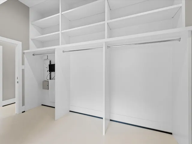 a living room with a bed and a window