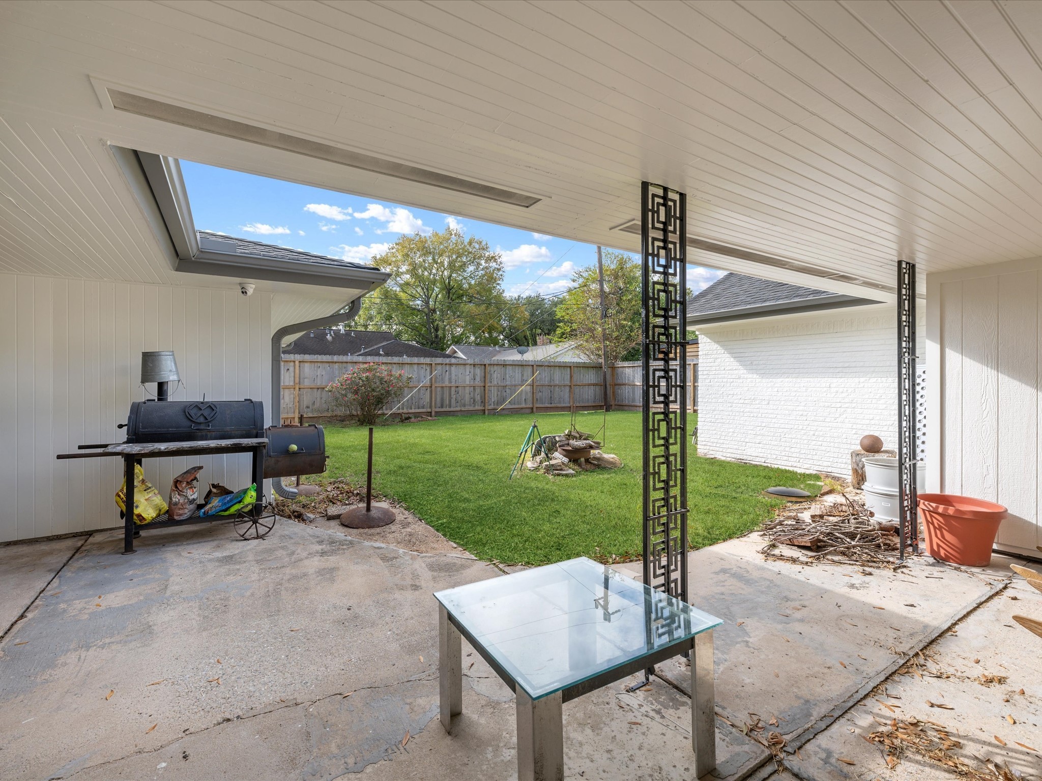 5603 Grape Street Houston, TX 77096 - Photo 31 of 40 a view of a patio with a table chairs and a backyard