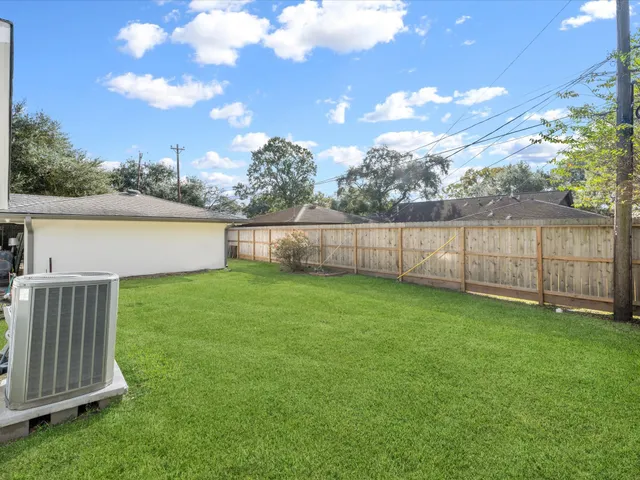 a view of an house with backyard space and garden