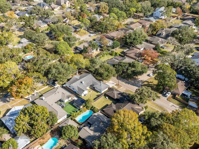 an aerial view of residential house with swimming pool and lawn chairs