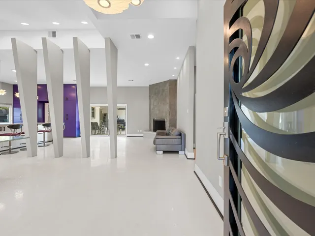 a view of a hallway with lots of dining room and furniture