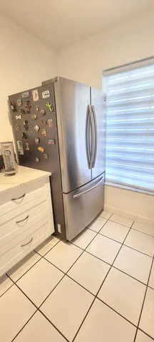 a view of a refrigerator and microwave
