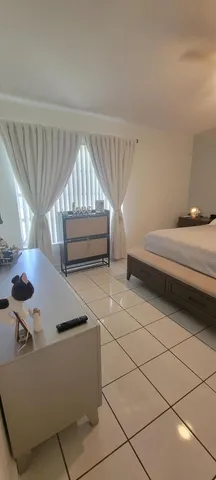 a bedroom with a bed and a night stand