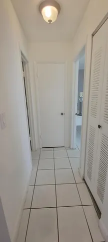 a view of a livingroom with wooden floor and a ceiling fan