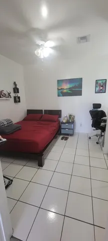 a bedroom with furniture and a window