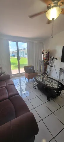 a view of house with yard outdoor seating