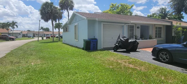 a view of small house with outdoor space